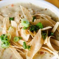 Roasted Corn And Chicken Chowder · Creamy soup with roasted corn and grilled chicken. Garnished with tortilla strips and green ...