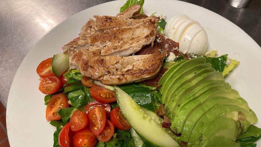 Cobb Salad · Bleu Cheese, Bacon, Hardboiled Egg, Avocado and Grape Tomatoes on a bed of Romaine lettuce. Served with Ranch dressing.