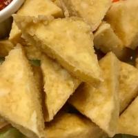 Fried Tofu (6) · Six pieces. Deep-fried tofu, served with sweet and sour sauce and crushed peanut.