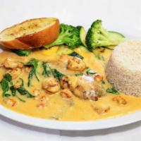 Redfish · Grilled Redfish Topped with a wine cream sauce shrimp and crawfish with 2 sides