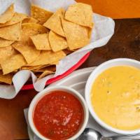 Queso And Chips · Add beef or blackened chicken for an additional charge.