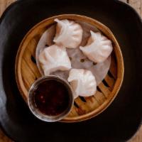 Shrimp Dumplings · Steamed shrimp dumplings served with soy chili sauce.
