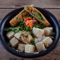 Tofu Vermicelli · Tofu, vermicelli, herb salad, sautéed onions, topped with peanuts and avocado spring roll.