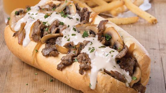 The Chipotle Philly · Grilled sirloin, caramelized onions and mushrooms, chipotle aioli and queso in a traditional hoagie
.