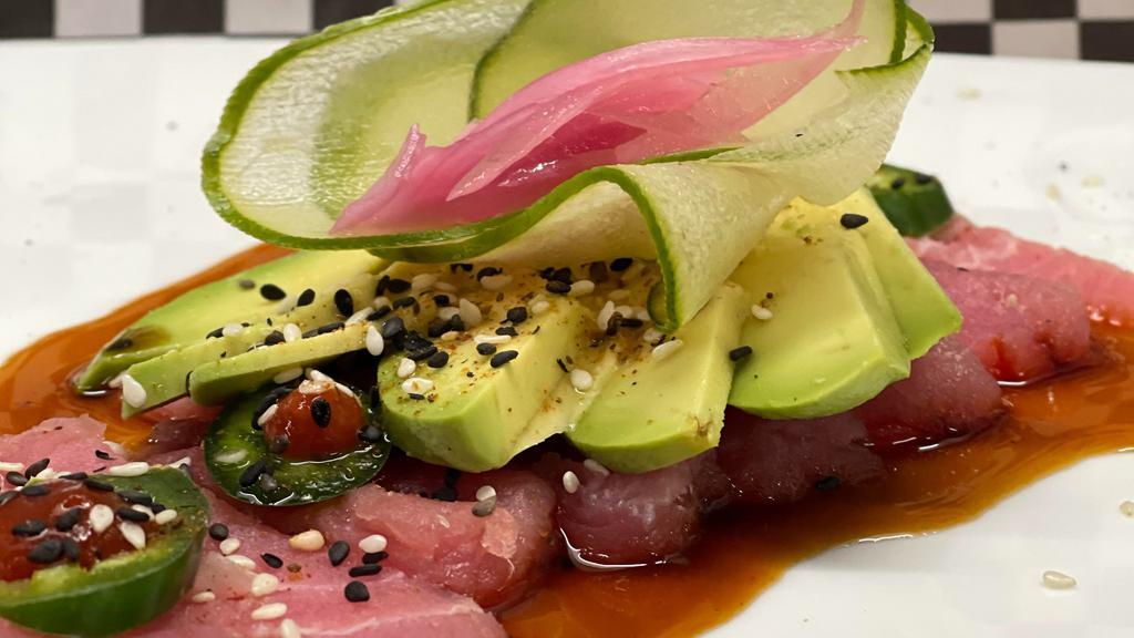 Tuna Sashimi · Fresh Ahi Tuna, Avocado, Red Onions, Jalapenos, Cucumber slices and Poke Dressing
