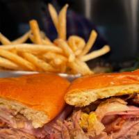 Cubano Islander Sandwich · House cooked Carnitas, Black forest ham, bacon, mustard, pickles, provolone and French bague...