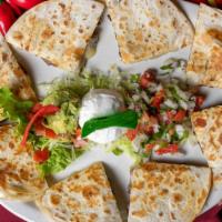 Veggie Quesadilla · Spinach, bell peppers, onions, and mushrooms. Served with guacamole, sour cream, and pico de...
