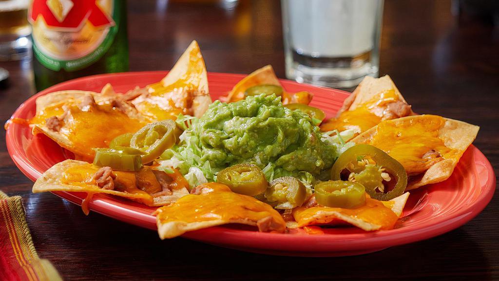 Nachos · Served with guacamole and jalapenos