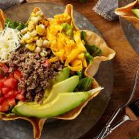 Taco Salad · A large crispy tortilla bowl filled  with fresh mixed greens topped with seasoned  chicken o...