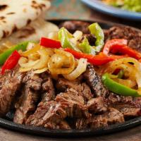 Large Angus Fajita Beef Serving · Served with sauteed onions, bell peppers, and complemented with lettuce, sour cream, pico de...