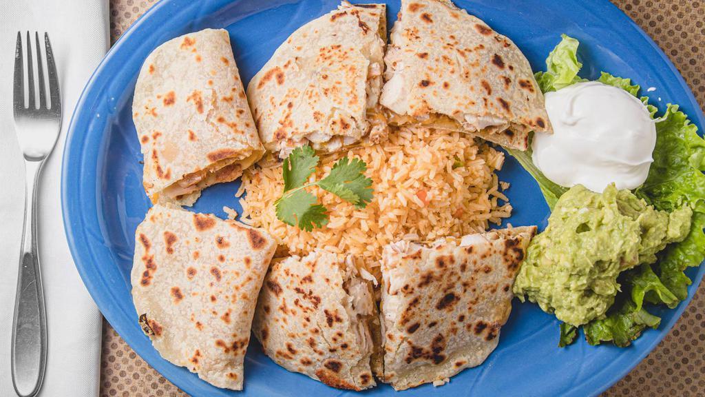 Quesadillas · Homemade tortillas stuffed with choice of grilled chicken or beef fajita, and jack cheese. Served with rice, guacamole, and sour cream.