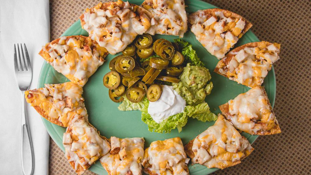 Mixed Nachos Haciendas · Topped with beans, chicken and beef fajita and cheese. Accompanied with guacamole, sour cream and jalapenos.