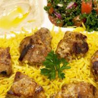 P10 Lamb Mashawi · Marinated Lamb Cubes, Over Rice and side of hummos and Tabouleh, Tomato Sauce and Pita