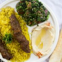 P11 Shish Kebab · Ground Beed on Skewer  Over Rice and side of hummos and Tabouleh, Tomato Sauce and Pita