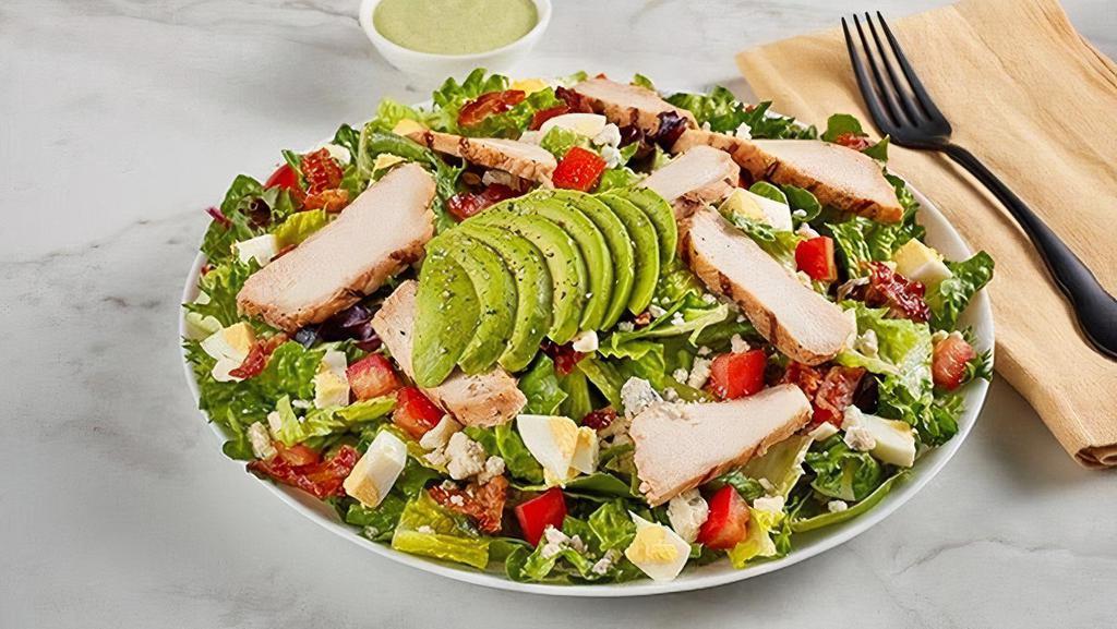 Green Goddess Salad · Green Goddess Salad is practically a perfect spring salad with sliced grilled chicken on mixed greens with tomatoes, gorgonzola cheese, chopped egg, applewood smoked. bacon and avocado, served with Green Goddess dressing.