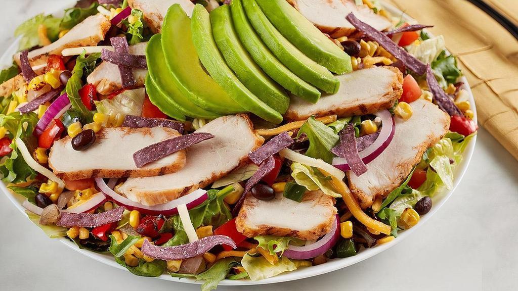 Southwest Chicken & Avocado Salad · Grilled chicken, roasted corn, pobablano and black bean relish, red onion, tomato, cheddar-jack, blue corn tortilla strips, and avocado on mixed greens.. Try it with Chili Lime Vinaigrette dressing.