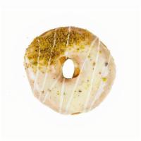 White Chocolate Pistachio · White chocolate icing with pistachio bits and pistachios sprinkled on top