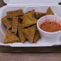 Fried Tofu · Crispy fried tofu. Served with sweet & sour sauce, mixed with ground peanuts.
