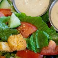 Sm Garden Salad · Romaine lettuce topped with cucumbers, tomatoes, black olives, croutons, and dressing of you...
