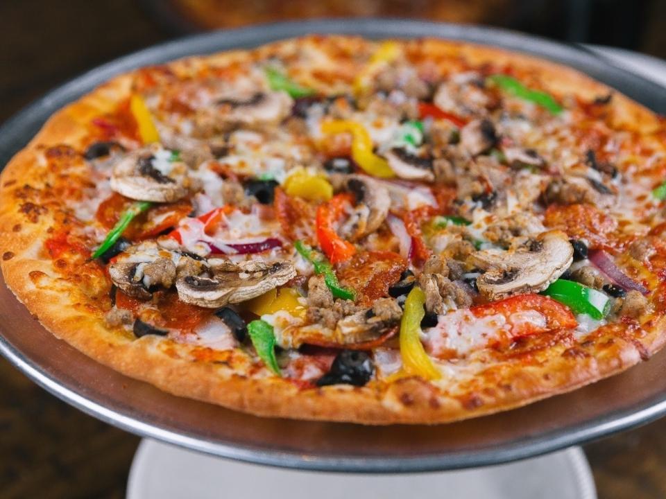 Large The King · Our most popular pizza!. All-natural red sauce pepperoni, sausage, Canadian bacon, fresh mushrooms, black olives, onions, red, yellow and green peppers.