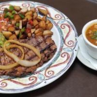 Carne Asada · Grilled flank steak topped with grilled onions. Served with Mexican potato, charro beans, gu...