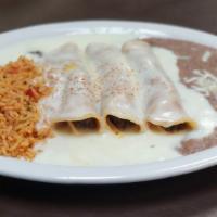 Enchilada Dinner · Enchilada dinner (3) with choice of cheese, picadillo beef or shredded chicken topped with r...