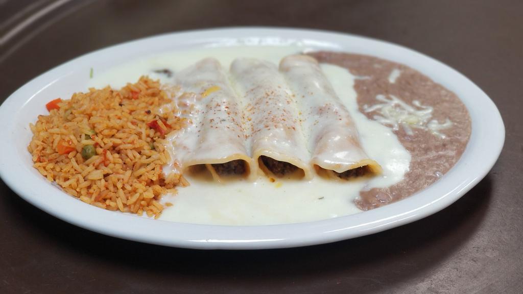 Enchilada Dinner · Enchilada dinner (3) with choice of cheese, picadillo beef or shredded chicken topped with ranchera sauce, tomatillo, chile con carne, cheese sauce or suizas.