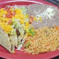 Tex-Mex Tacos · Three ground beef or shredded chicken tacos, crispy or soft, served with Mexican rice and re...