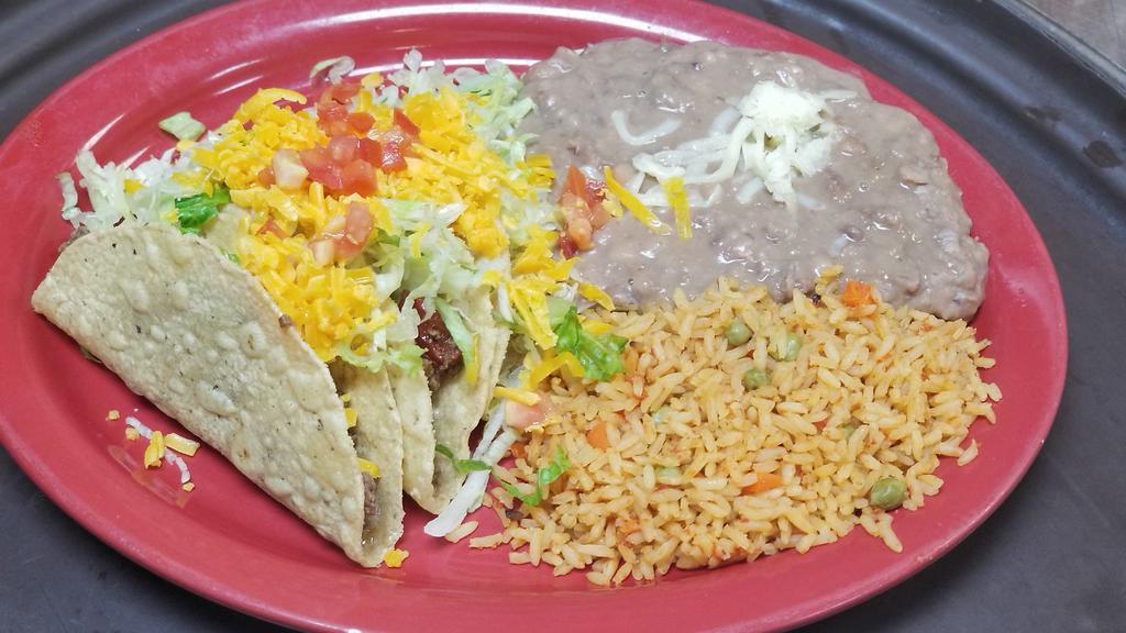 Tex-Mex Tacos · Three ground beef or shredded chicken tacos, crispy or soft, served with Mexican rice and refried beans.