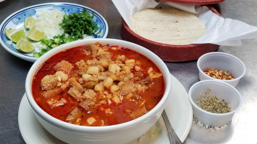 Menudo · Traditional Mexican red menudo made with beef stripe. Served with a side of fresh jalapeños, onion, cilantro and lime.