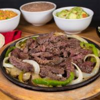 Parrillada Beef Fajitas · Includes rice, refried beans, guacamole, and tortillas.