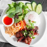 Cơm Tấm Phi · One of our most popular items. Broken rice, egg, skin pork, bbq pork, veggies, fish sauce.