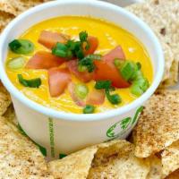 Chips & Queso · Plant-based nacho cheeze sauce topped with tomato and green onion. Organic tortilla chips sp...