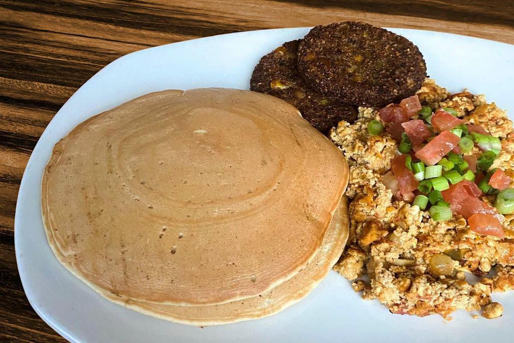 Vegan Breakfast Platter (Vg) · We got you, Vegans. Two Dr. Praeger’s veggie patties & tofu scramble topped with green onions & fresh diced tomatoes. Served with two half size pumpkin vegan pancakes.