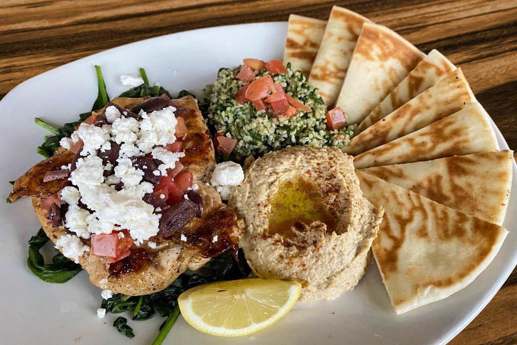 Greek Chicken · Grilled all natural chicken breast, sautéed spinach, diced tomato, Kalamata olives, feta cheese, homemade hummus, & tabbouleh. Served with grilled pita bread.