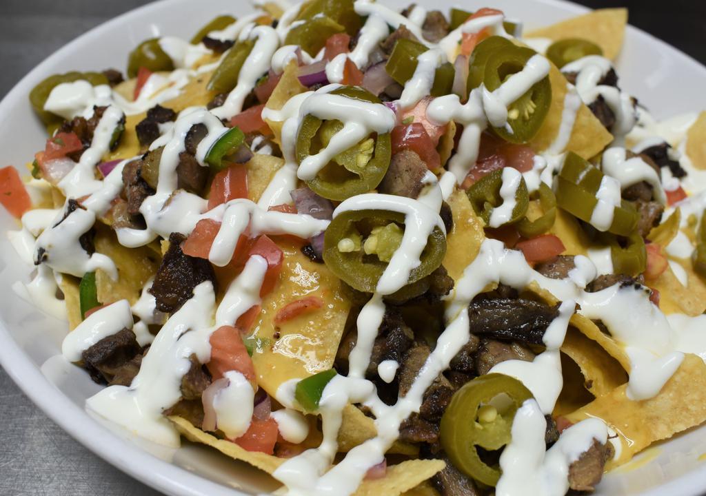Macarthur'S Supreme Commander Nachos · A heaping helping of tortilla chips piled high with chicken or steak, spicy queso, jalapeno, sour cream and pico.