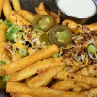 Locked & Loaded Cheese Fries · Crispy fries fried high, smothered with jack, cheddar and spicy queso cheese then topped off...