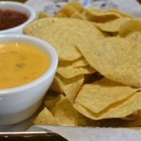 Chips & Queso · Creamy golden queso cheese blended with tomatoes, onion, peppers and cilantro. Served with t...