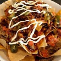 Mp Pulled Pork Nachos · Tortilla chips filled high and topped with tender shredder pork, spicy queso and cheddar che...