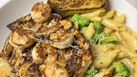 Renegade Pasta · A little Cajun flairi penne pasta tossed in a creamy spiced Alfredo sauce with fresh broccoli and mushrooms. Topped with blackened chicken and shrimp, served with a side salad and garlic toast.