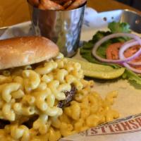 The Mac Burger · Homemade mac and cheese piled high on our Angus burger, topped off with more cheddar cheese.