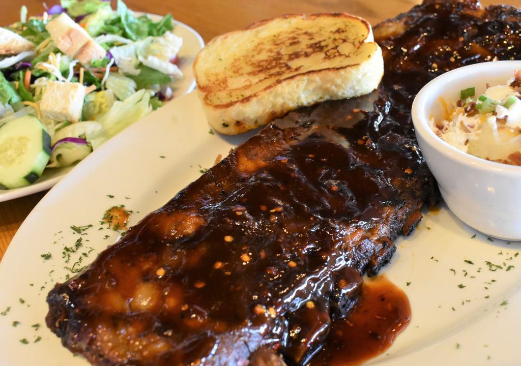 Spirit Of St Louis · St louis style ribs slow cooked and grilled to perfection. Brushed with our signature sweet n spicy, American born moonshine BBQ sauce. Served with 2 side and garlic toast.
