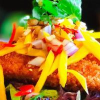 Golden Mango · Fried tilapia with lightly panko, on bed of green and side of a mixture of mango, red onions...