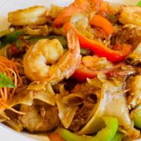 Pad Kee Mow (Drunken Noodles) · Wok tossed, big flat rice noodles, egg, garlic, chilies, bell pepper, tomatoes and basil lea...