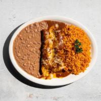 Beef Enchiladas · Two picadillo beef enchiladas in chile con carne with cheese. Served with Mexican rice, refr...