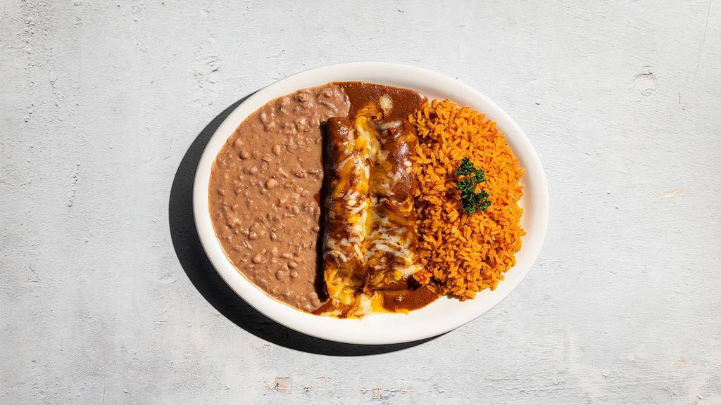 Beef Enchiladas · Two picadillo beef enchiladas in chile con carne with cheese. Served with Mexican rice, refried beans, and chips. Contains dairy and nightshades. We cannot make substitutions.