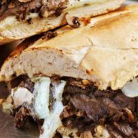 Philly Cheese Steak Sub · An oven-baked, 8-inch baguette with creamy white American cheese and seasoned steak with oni...
