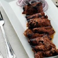 Beef Bihari Kabab · Barbecued thin juicy slices of beef marinated in fresh herbs.