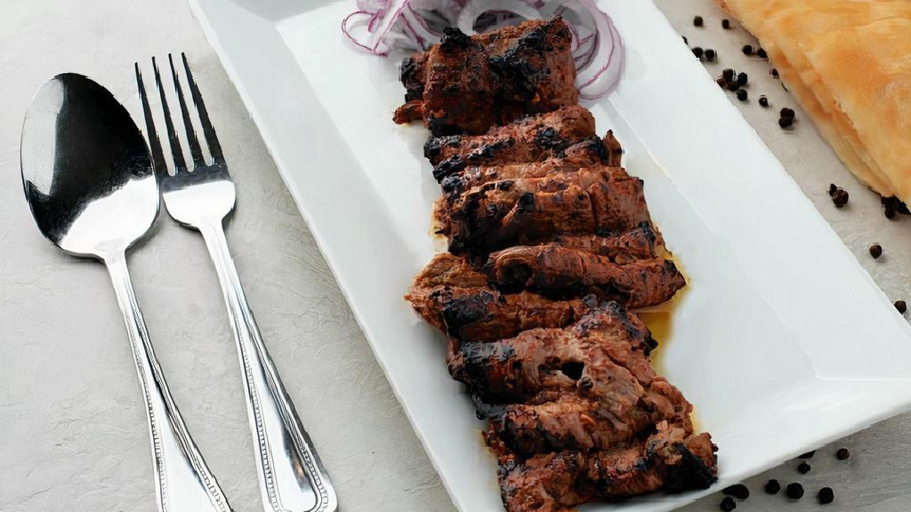 Beef Bihari Kabab · Barbecued thin juicy slices of beef marinated in fresh herbs.