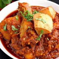 Chicken Vindaloo · Tender pieces of bone-in chicken and potatoes cooked in a hot spicy sauce.